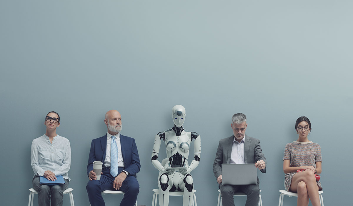 Image shows a lineup of four individuals with one humanoid robot in the center seated side by side against a plain, light grey background. From left to right, there is a young woman wearing glasses and a striped shirt, holding a notebook; a bald man in a suit and tie holding a coffee cup; the robot, which is white with black accents and has a humanoid shape but with a distinctly mechanical design; a middle-aged man checking a wristwatch, also in a suit; and a young woman with glasses, wearing a patterned dress and holding a red folder on her lap. They all sit on white stools, spaced evenly apart, and appear to be waiting for something, evoking a sense of a waiting room or interview scenario. The scene is a conceptual representation of the integration of technology and artificial intelligence with human activity in a professional or corporate environment.